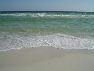 Crystal clear gulf water and white sand beach.