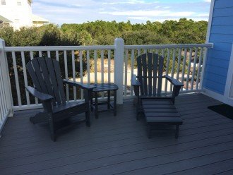 2 Adirondack chairs on deck outside dining room next to screened in porch