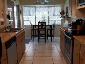 Kitchen with all amenities, sliders to pool & lanai.