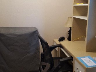 Small Office area with desk, phone and hardline for computer.