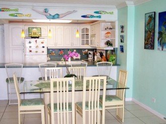 Dining Room and kitchen adorned with marine and island art.