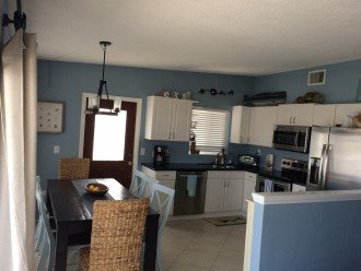 Fully Stocked Kitchen and dining for 8. Open to living room and views of canal.