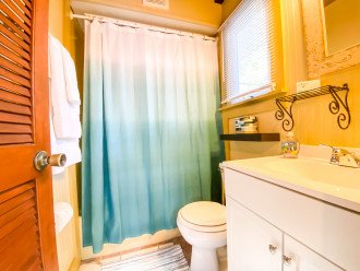 Bathroom has a tub/shower combination.