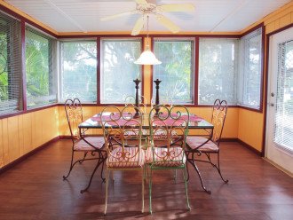 Dining room is surrounded by lush tropical gardens views