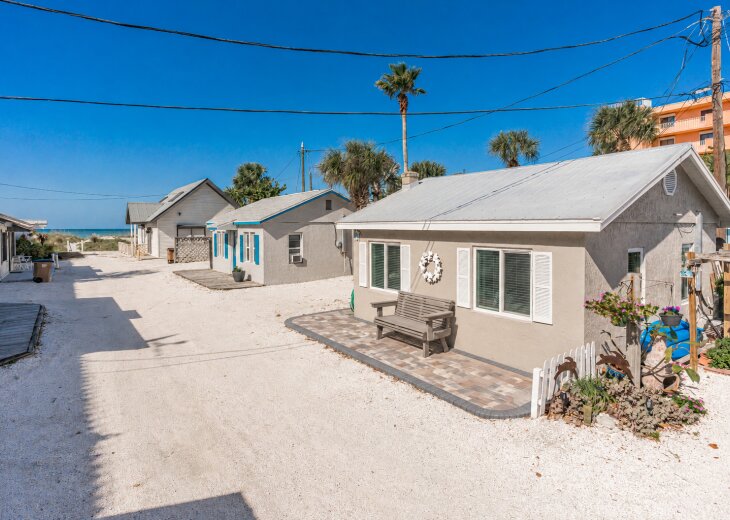 Charming beach cottage situated just 55 steps from the sandy shore. Enjoy a peaceful coastal neighborhood with palm trees and ocean breezes, perfect for an unforgettable seaside escape.
