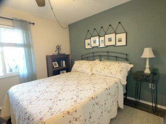 The guest bedroom features a queen bed, linens, fan/light remote.