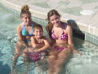 three of my grand kids enjoying one of the hot tubs at the beach
