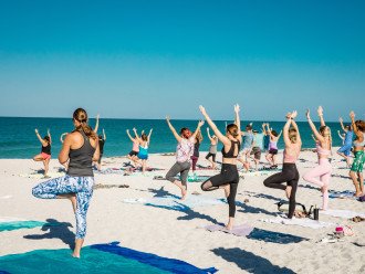 Start your day off with beach yoga