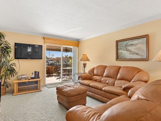 Plush leather furniture and wall mounted flat screen TV for relaxing.