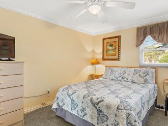 The second bedroom has a comfortable queen bed, flat screen TV and dresser.
