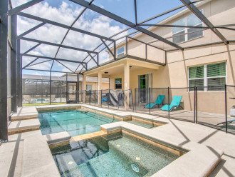 Screened backyard with heated pool and spa, BBQ, dinning table and lounge chairs