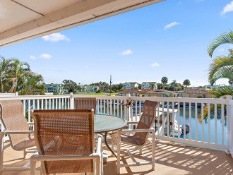 Sit waterside at your covered back deck area and watch boats and dolphins.