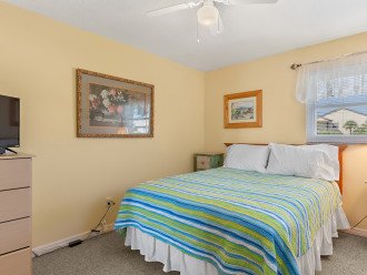 The second bedroom has a comfortable queen bed, flat screen TV and dresser.