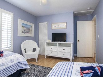 Twin Rooms with TV and dresser.