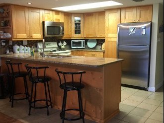 Full size kitchen with granite tops and stainless appliances