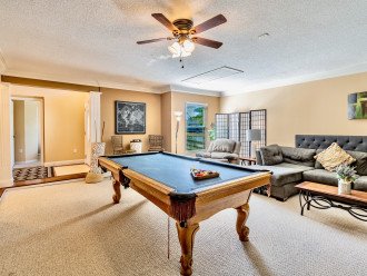 Just of the hallway is a second living space with pool table