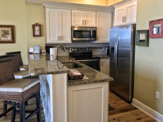 Updated kitchen with shaker cabinets and granite