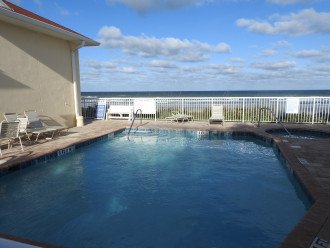 pool and spa at beach club overlooking ocean