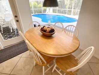 Breakfast table with views over the pool and the creek