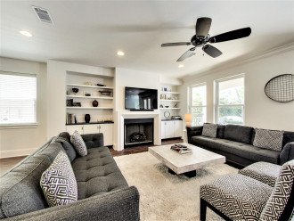 Bright and Open Living Area with Fireplace and Flat Screen TV