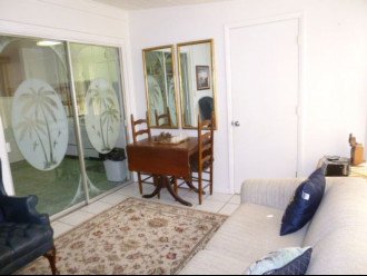 Florida room with pullout sofa, drop-leaf table, CD player.
