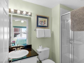 1st guest bedroom ensuite with walk in shower, vanity with granite countertop & extra storage
