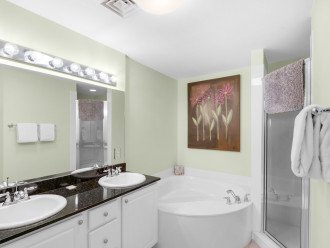 Large master en suite with dual vanity sinks,storage, soaking tub, walk in shower & walk in closet
