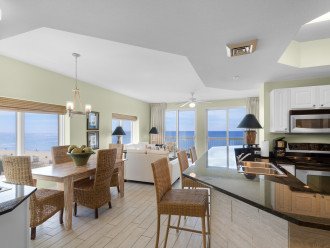 Kitchen, bar, dining area and main living area surrounded with Gulf views