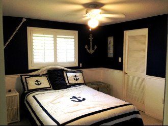 Nautical bedroom with walk in closet.