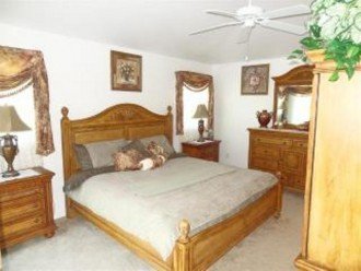 Stylish decorated master bedroom with TV and direct access to lanai