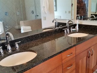 Double vanity in master with high-end fixtures and cabinetry.
