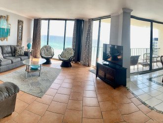 Living room/dining room and balcony overlooking the beach