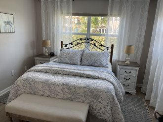 Guest bedroom with 3 drawer night tables and bench