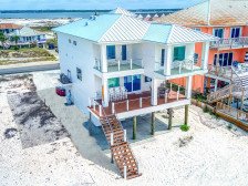 Step directly onto the sugar white sands from this BRAND NEW Gulf Front Home!