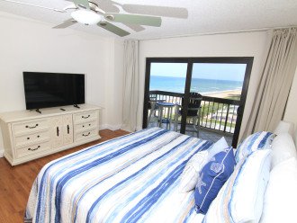 Master bedroom with an ocean view and TV