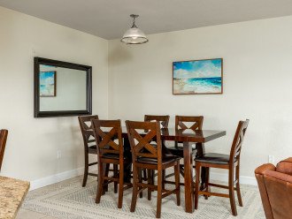 Seating for 6 at the dining room table with extra bar stool chairs in the kitchen