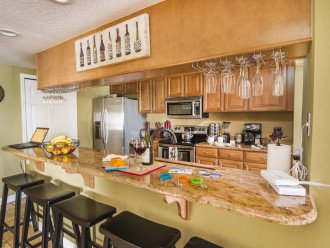 Upscale Kitchen with Granite Counters, Wine Rack and Lunch Bar that Seats 5