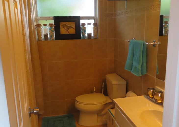Hall bathroom with tub/shower combination and washer/dryer.