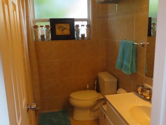 Hall bathroom with tub/shower combination and washer/dryer.