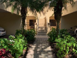 Lush entrance to condo with parking directly behind the walk
