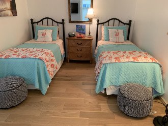 Twin beds in second bedroom with 40-inch Roku TV