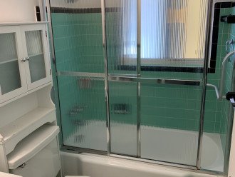Single bathroom with tub/shower plus handrails. Towels in hall closet