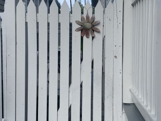 Closed access gate to back patio and trash/recycle receptacles