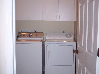 Laundry, sink, ironing board/ iron, broom closet w/ shark vacuum & steam cleaner