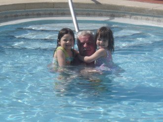 Papa and girls in the pool