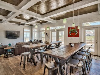 french doors open to pool, high-top pub tables plus barstools at kitchen island