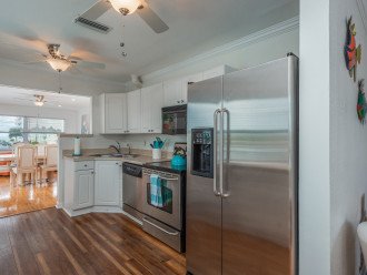 Full size kitchen with stainless steel appliances (fridge, dishwasher, oven)