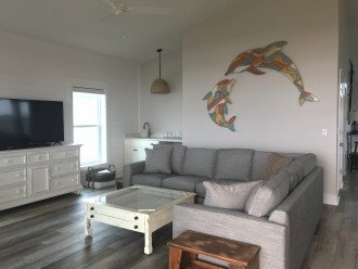 Living room with custom artwork ( includes views of the beach)