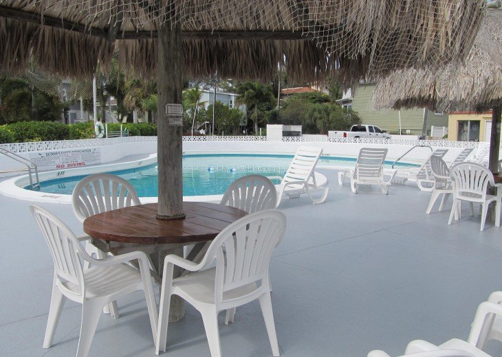 Pool with Tiki Umbrellas and lounge chairs
