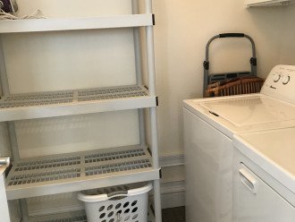 Laundry room with extra shelves for food, drinks, coolers & extra dining chairs